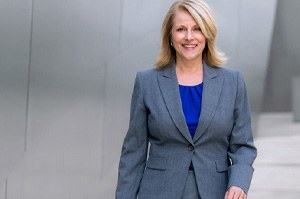 Smiling middle-aged businesswoman outside of office building