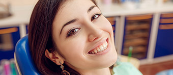 Young brunette woman smiling widely
