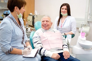 Senior patient smiling because of comfortable tooth extraction