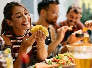 Woman enjoying tacos with friends