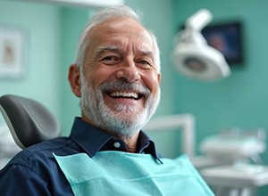 Smiling senior patient in dental treatment chair