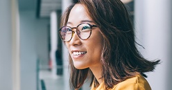 Smiling young woman in glasses