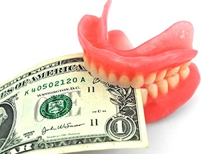 Dollar bill gripped between upper and lower dentures