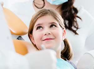 Young girl smiling in dental chair