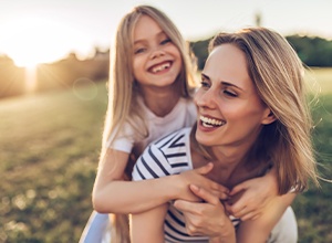 woman holding smiling child