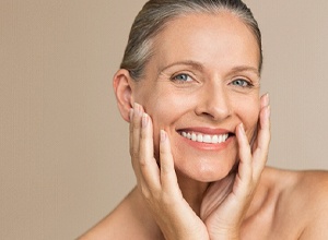 Beautiful senior woman enjoying benefits of implant dentures