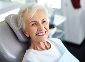 Smiling senior woman in dental treatment chair