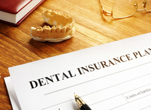 Dental insurance plan document on desk