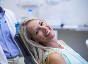 Smiling patient leaning back in treatment chair