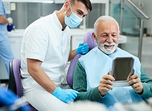 Happy older man attending a preventive checkup with his dentist