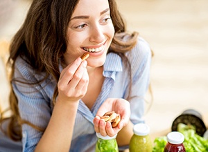 Woman with nice teeth enjoying a healthy snack