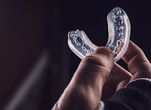 Close-up of athlete’s hand holding a mouthguard for sports