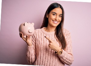 Woman smiling while holding piggy bank
