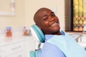 Dental patient smiling prior to tooth extraction in Abington