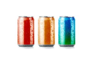 Three cans of soda against white background