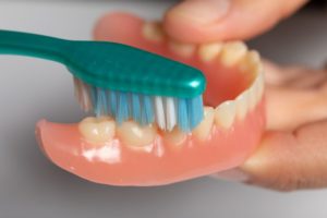Close-up of denture and toothbrush