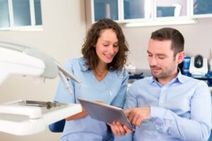 Dentist and patient discussing treatment options during emergency visit