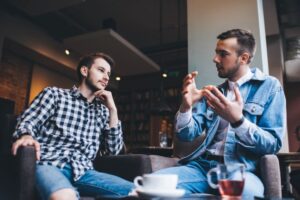 Two male friends enjoying a casual conversation 