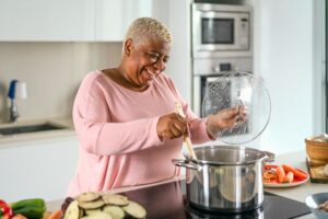 Senior woman preparing a nutritious soup