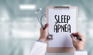 Doctor holding a clipboard that says, &ldquo;sleep apnea&rdquo; 
